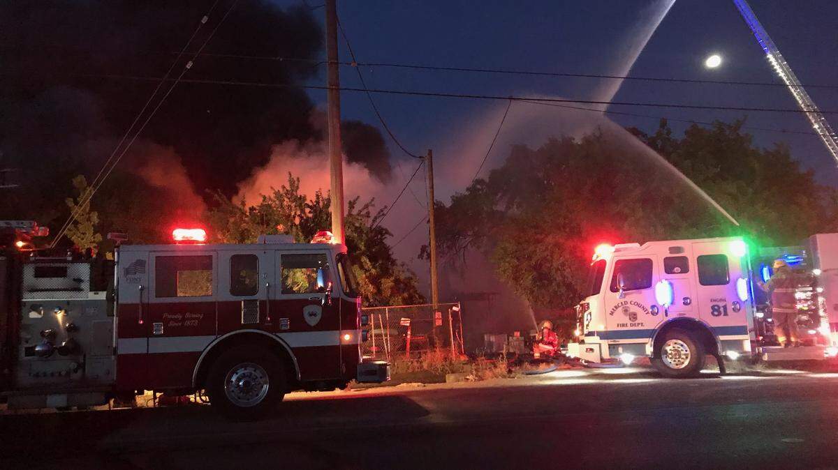 Firefighters work to put out a fire at an abandoned residential structure on East Childs Avenue early on Sunday, June 7, 2020 in Merced, Calif.