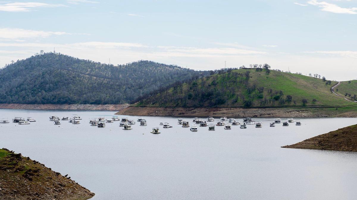 Houseboats float on the water at Lake McClure in Mariposa County, Calif., on Monday, Feb. 24, 2025.