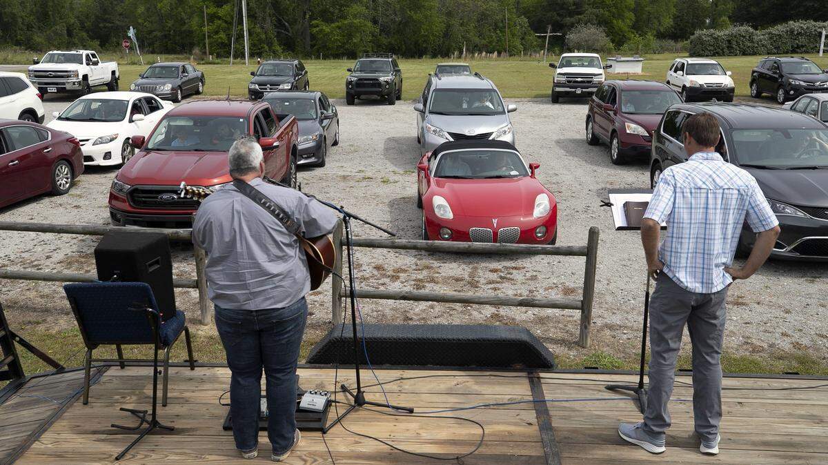 LifePoint Community Church worship pastor Troy Bullard, left, and pastor Nathan Redinger lead a drive-in worship service on Sunday, April 19, 2020, in Willow Spring, N.C. Merced County Department of Public Health on Friday expanded essential services to include drive-in services for churches and faith-based organizations. 