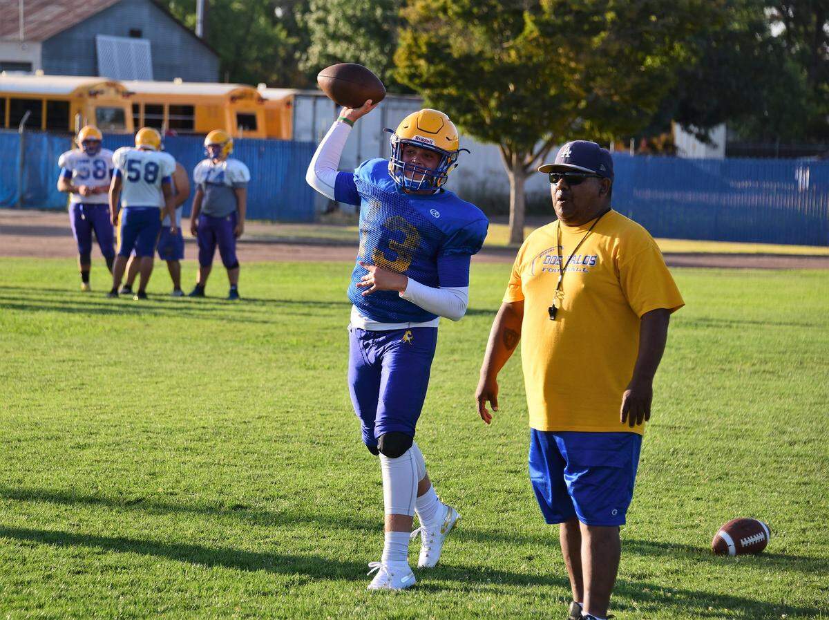 Dos Palos sophomore quarterback Trent Calvert throws a pass during a Broncos practice this summer. Calvert is one of six sophomores who could start this season for Dos Palos.