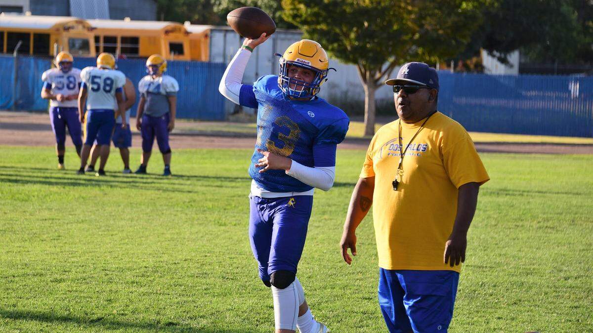 Dos Palos sophomore quarterback Trent Calvert throws a pass during a Broncos practice this summer. Calvert is one of six sophomores who could start this season for Dos Palos.