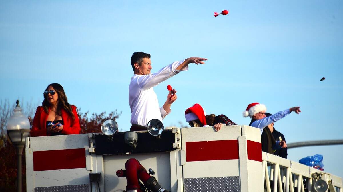 Merced mayor Mattew Serratto tosses toy footballs to kids in the crowd during the annual Merced Christmas Parade on Saturday, Dec. 2, 2023 in Merced, Calif.