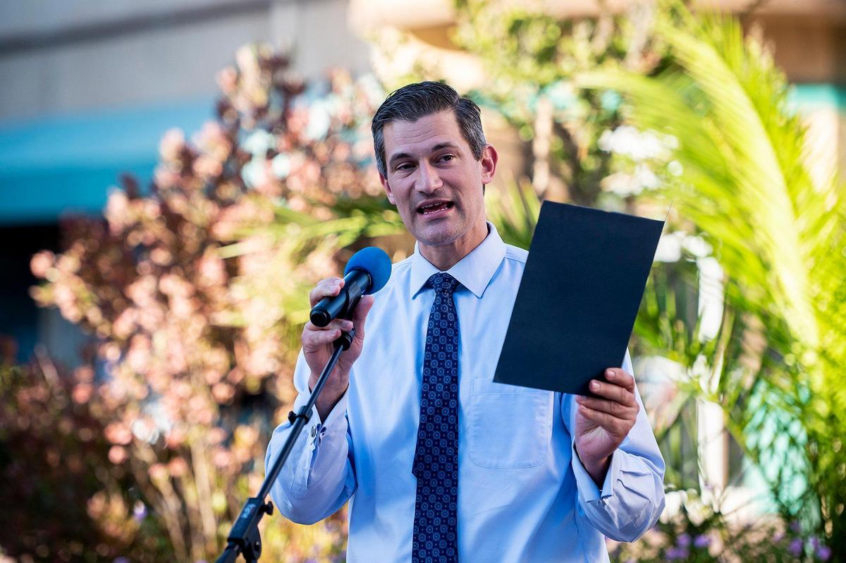Merced Mayor Matthew Serratto reads proclaims June, 2022, LGBTQIA+ Pride Month in the city during the Pride Progress flag raising ceremony at Bob Hart Square in Merced, Calif., on Wednesday, June 1, 2022. The Merced City Council approved the addition of the flag to the regular flag calendar, meaning the flag will fly over Bob Hart Square annually during the month of June.