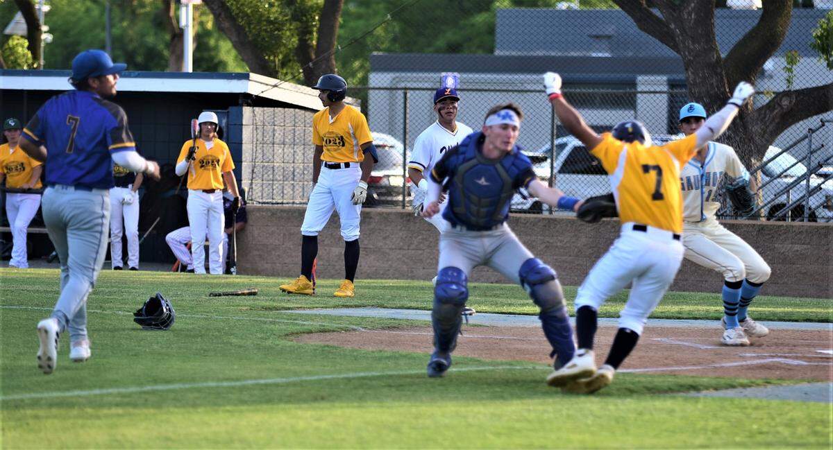 Merced County catcher Peyton Van Worth of Dos Palos tags out Stanislaus County’s Felix Daclan of Gregori during the first inning of the County Clash All-Star Game at Merced College on Saturday, June 17, 2023.