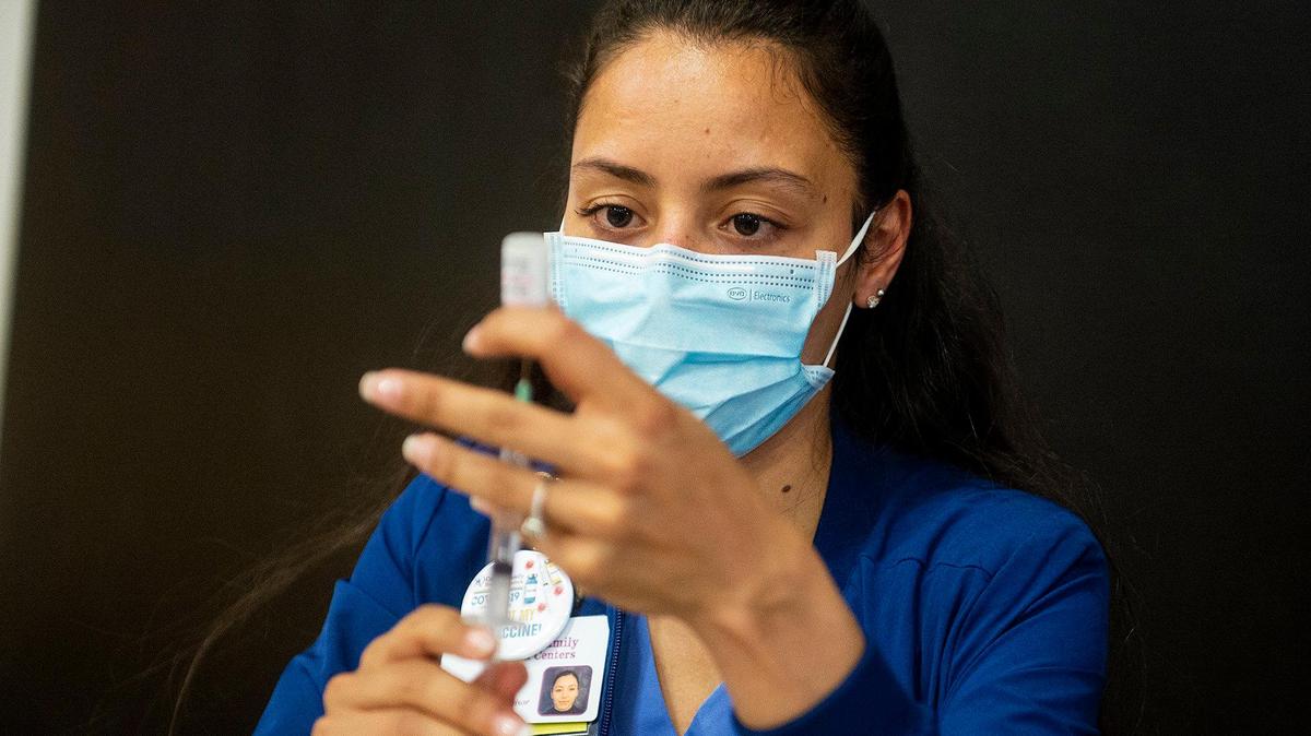 There’s been a raging debate about vaccine “passports” in California, even though the state is not proposing such a program. Here, Laura Figuero fills a syringe with the Pfizer COVID-19 vaccine during a vaccination clinic held by the Merced Union High School District.