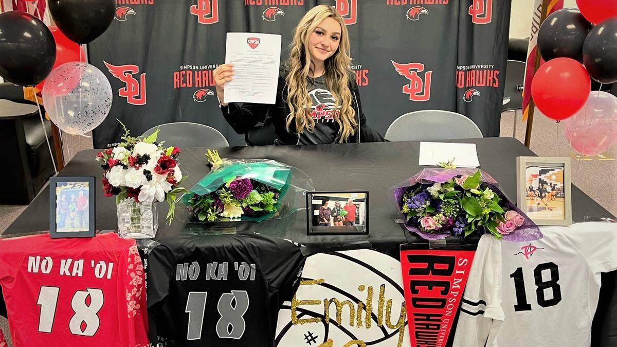 Buhach Colony senior Emilly Melo holds up her national letter of intent after recently signing to play volleyball at Simpson University during a ceremony at Buhach Colony High School in Atwater, Calif.
