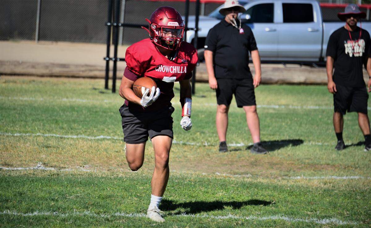 Chowchilla High School senior Joey Garcia runs the ball during practice on Wednesday, Aug. 10, 2022.