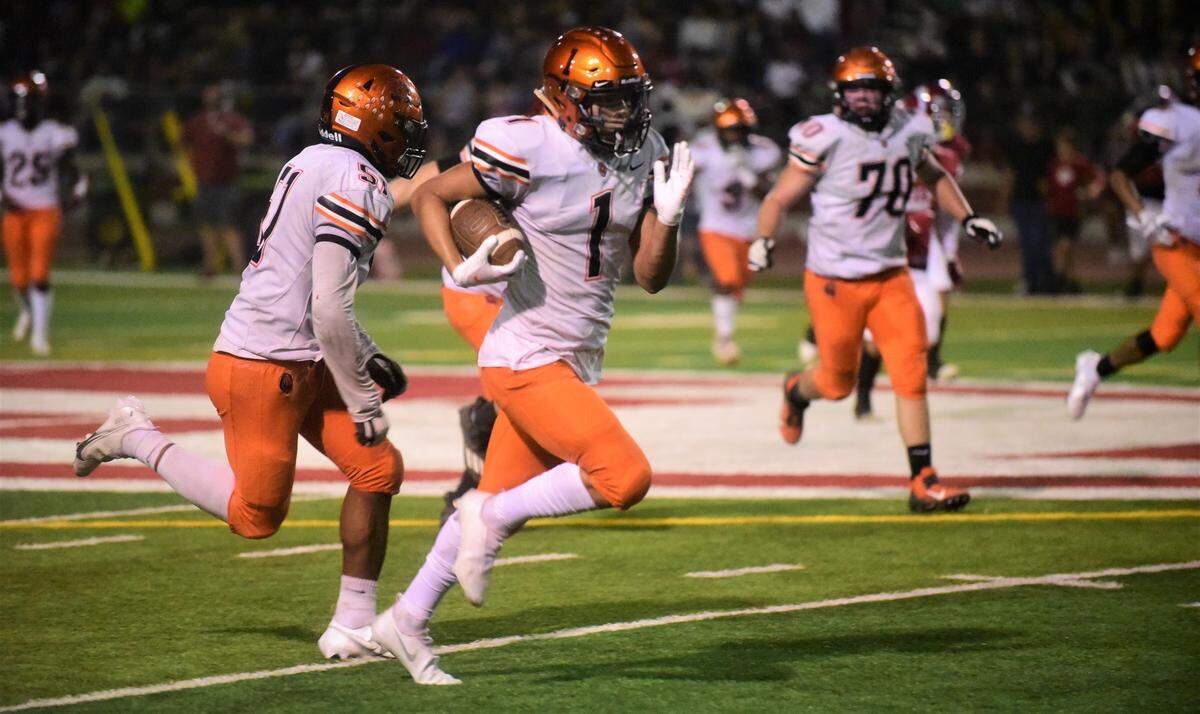 Merced senior receiver Evahn Perez streaks down the field during a 52-yard touchdown catch during a game against Patterson at Patterson Community Stadium on Friday, Sept. 24, 2021.