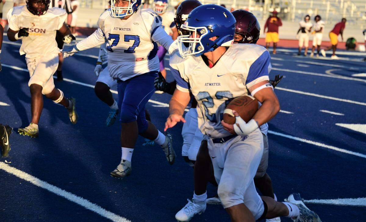 Atwater High School junior Jeremiah Dela Rosa (23) carries the ball during a scrimmage against Edison of Stockton on Friday, Aug. 11, 2023 at Dave Honey Stadium in Atwater, Calif.