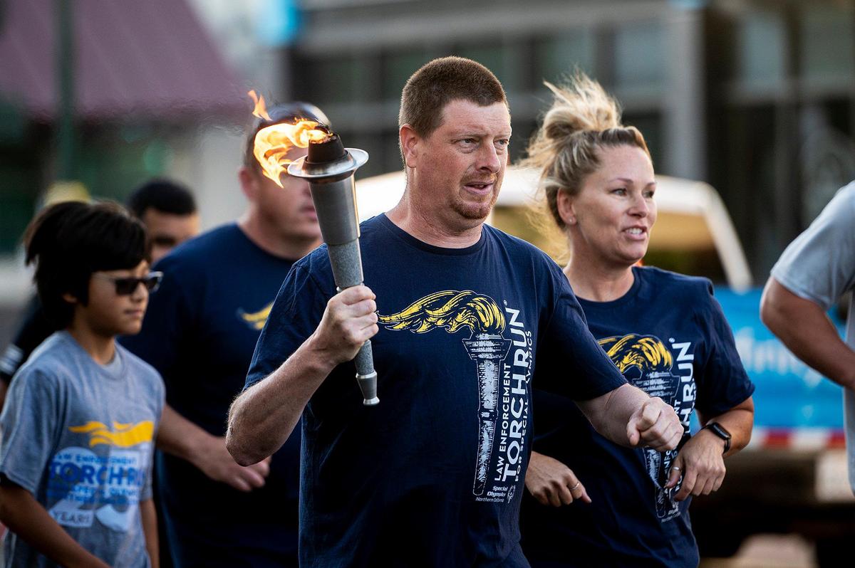 Special Olympics athlete and Merced resident Mark Heffner, 41, carries the torch and “Flame of Hope” during the Law Enforcement Torch Run for Special Olympics Northern California in Merced, Calif., on Thursday, June 15, 2023.
