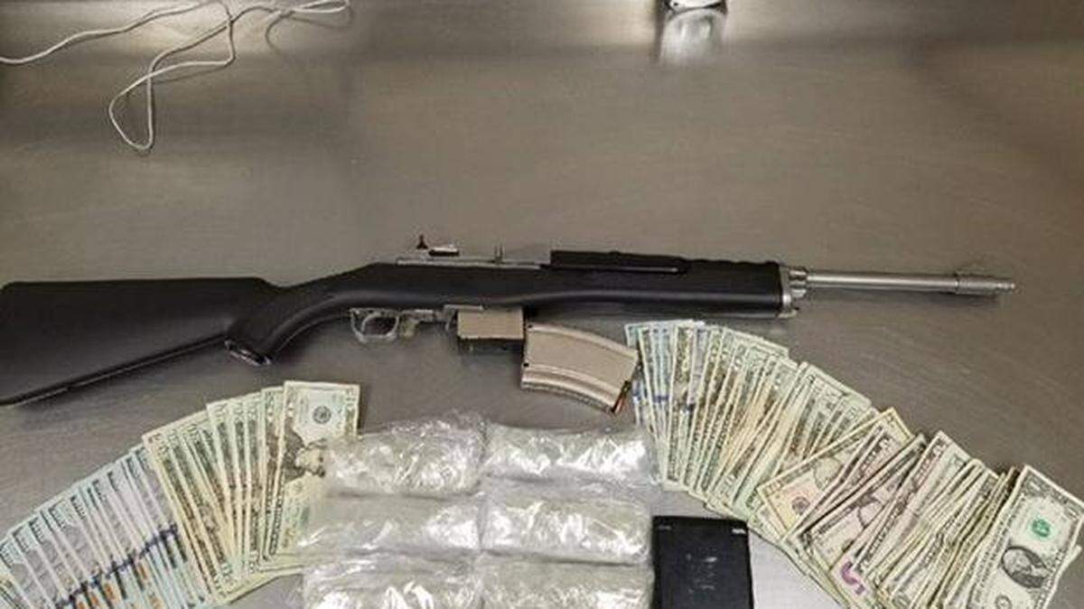 The rifle, guns and cash allegedly in the possession of three gang members on Wednesday, Jan. 3, 2017, according to Merced police.