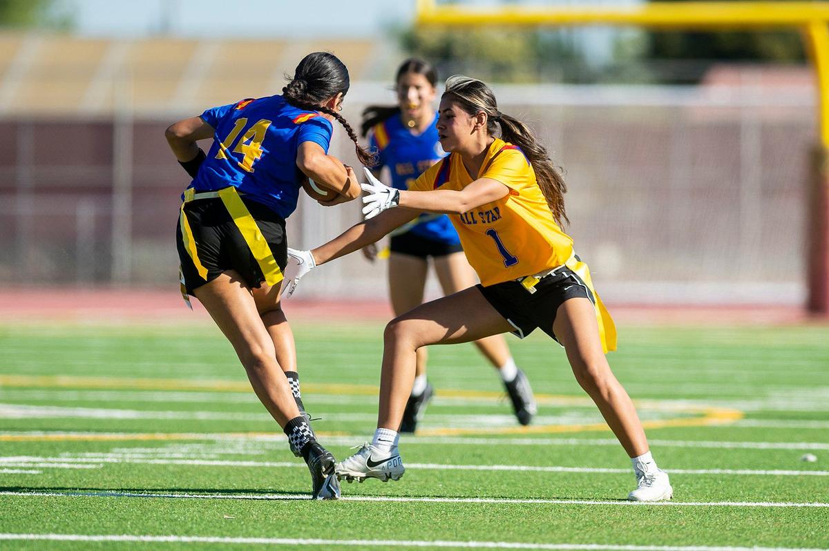 Gold All-Star Emilia Gomez (1) representing Merced, attempts to stop Blue All-Star Imelda Beltran Pelayo (14) representing Orestimba during the Merced County All-Star Girls Flag Football Game at Golden Valley High School in Merced, Calif., on Saturday, June 15, 2024. The Blue All-Stars beat the Gold All-Stars 20-12.