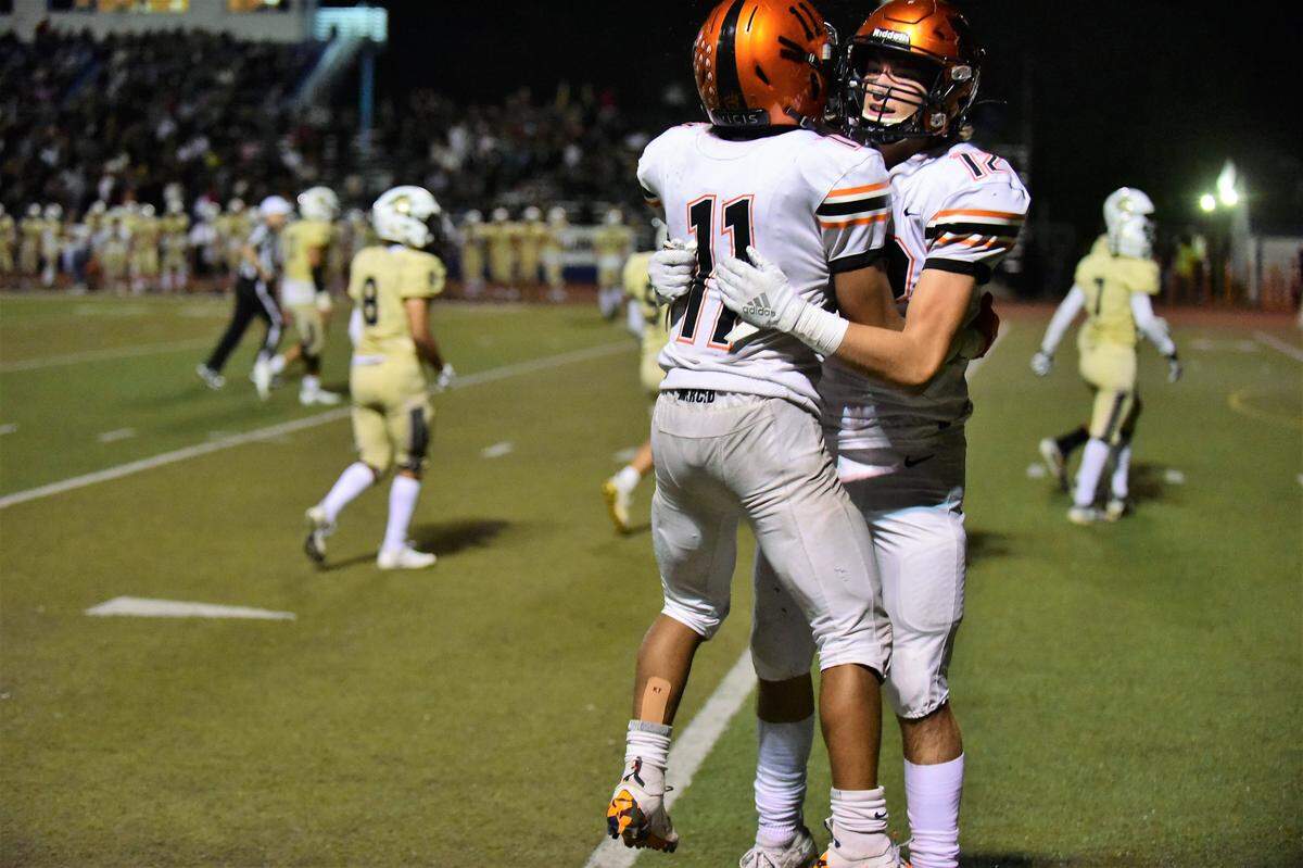 Merced’s Desmon Thompson (11) celebrates a touchdown with teammate A.J. Cheeseborough during a game against Buhach Colony on Friday, Oct. 11, 2019.