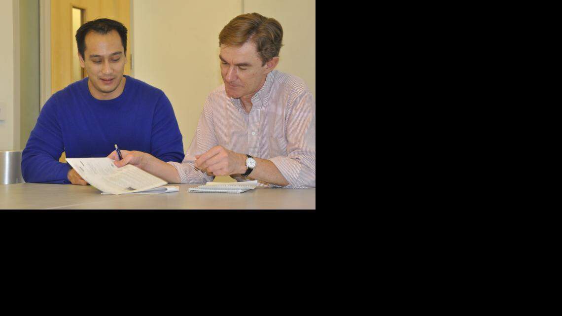 
Larry Johnson, left, and David Ojcius discuss the work Johnson will do in Brazil.
