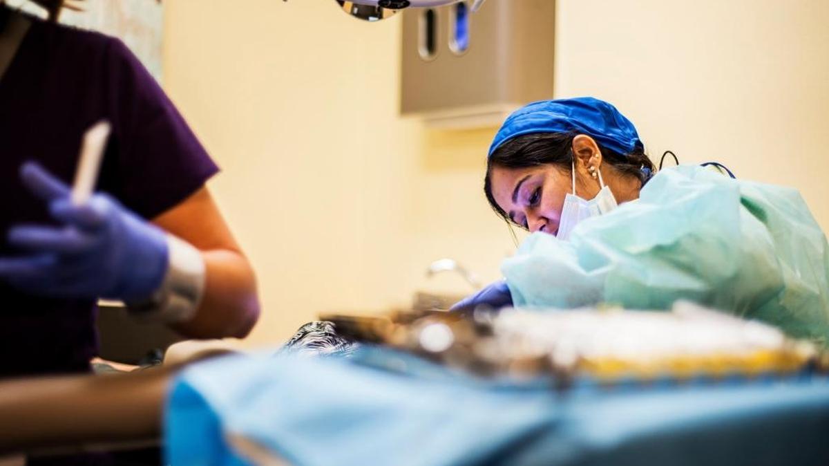 Dentist Remya Niranjan tends to a patient at the Livingston Community Health dental clinic at 7970 Lander Ave. in Hilmar in May.