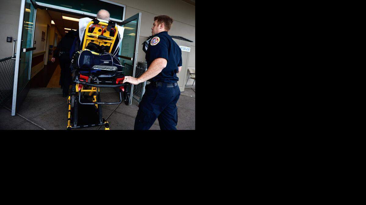 
Riggs Ambulance Service paramedics transport a patient to the Mercy Medical Center emergency room in Merced on Friday. According to the hospital, emergency room visits between July and December increased from 31,885 in 2013 to 33,118 in 2014.
