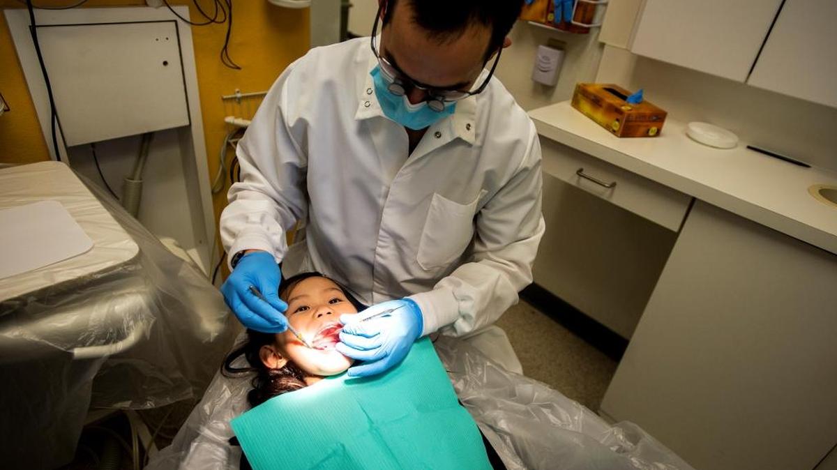 Doctor Kasey Perry, DDS performs a general exam on Nakita Vang, 5, of Merced, at the Golden Valley Health Centers located at 737 West Childs Avenue in Merced, Calif., Thursday, Feb. 11, 2016. According to child advocacy organization Children Now, more than half of emergency room visits for dental problems are children between the ages of zero and 6.