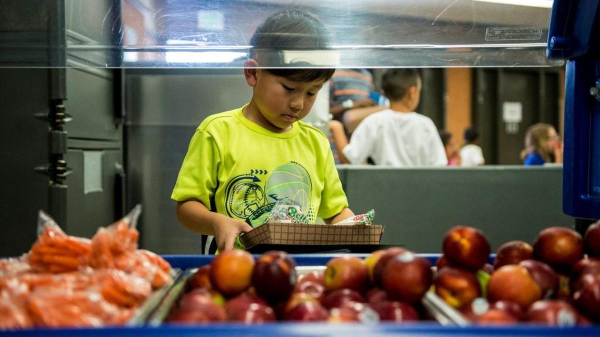 Chufu Her, 8, a student at Ada Givens Elementary School, checks out the fruit during the Merced City School District's Summer Meals Program at Peterson Elementary in Merced, Calif., Thursday, July 7, 2016. The Atwater Elementary School District begins their program on June 6 and the Merced City School District begins on June 12. Both programs last through July and no applications or enrollment is needed.