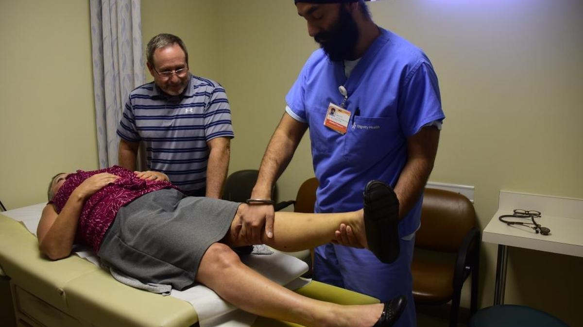 Dr. Gurraj Singh Bedi, a third year resident at the Mercy Medical Center's Family Practice Clinic, exams the knee of Kathy Loucks, 54, on Sept. 7, 2017.