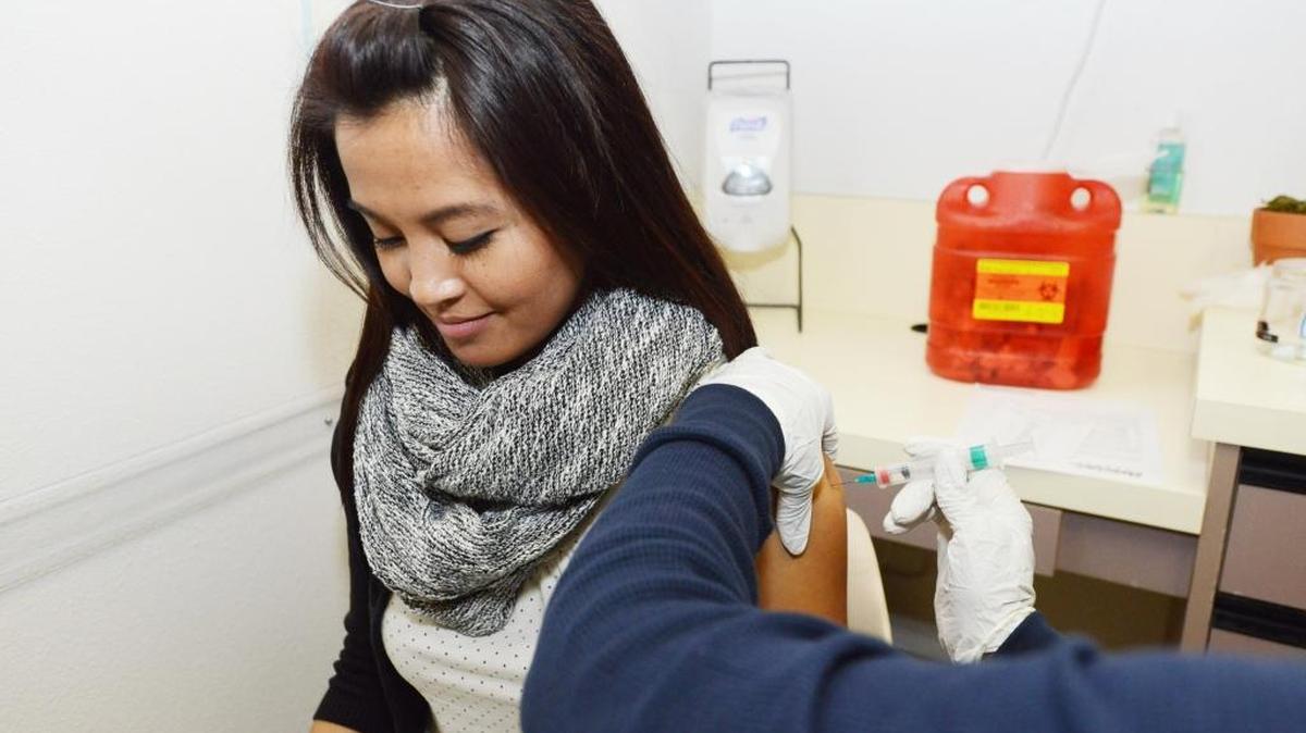 
Supervising public health nurse Annie Carlson gives a flu vaccine to Jocelynn Cruz of Tracy in 2014.
