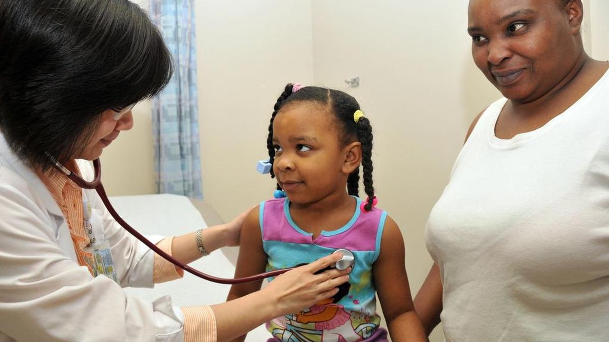 
SUN-STAR FILE PHOTO Dr. Theresa Chang, left, checks out Keiunandra Jackson, 5, while her mother, Rochelle Jenkins, looks on. More than 3,400 cases of whooping cough have been reported in the state so far in 2015. 
