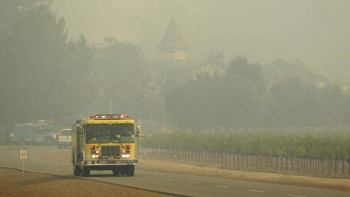 A fire truck makes its way through the Chateau St. Jean winery, Tuesday, Oct. 10, 2017, in Kenwood, Calif. Workers in Northern California's renowned wine country picked through charred debris and weighed what to do with pricey grapes after wildfires swept through lush vineyards and destroyed at least two wineries and damaged many others.