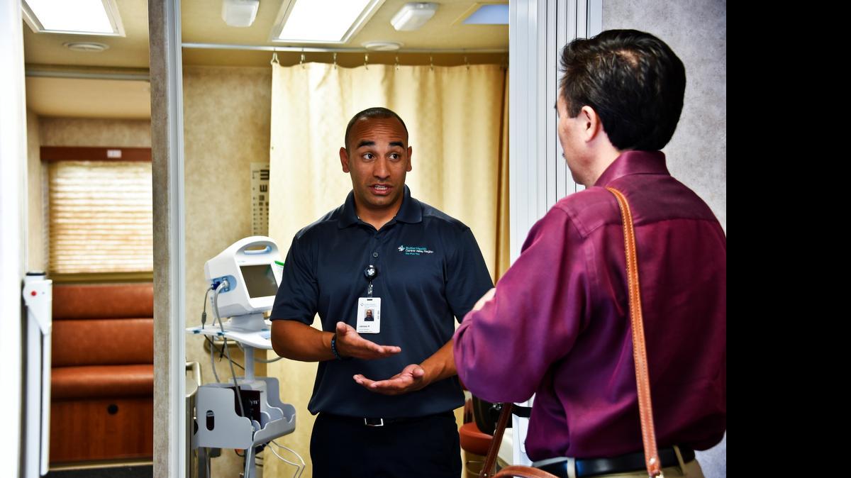 
James Huizar, the driver of Sutter Health’s new mobile health clinic, shows Brian Mimura, program manager with the California Endowment, around the unit. The mobile clinic will be used to provide services to uninsured residents in Merced, Stanislaus and San Joaquin counties.
