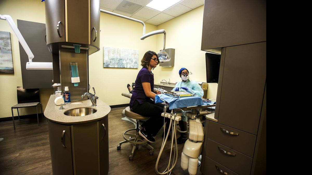 
Dentist Remya Niranjan, right, and Dental Assistant Marinna Rodrigues tend to a patient at the new Hilmar Health Center Dental Clinic located at 7970 Lander Ave. in Hilmar on Wednesday. The clinic opened Monday.
