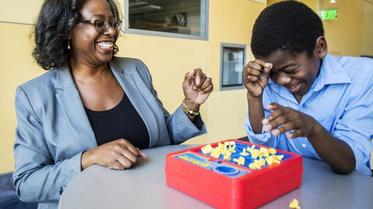 
Los Banos resident and doctoral candidate Nikko Da Paz, left, laughs with her son Evilasio, 9, while playing the game Perfection inside the Social Science and Management Building at UC Merced on Friday. Da Paz is in charge of a summer research project studying the mental and physical distress experienced by parents of children with autism spectrum disorder. Evilasio was diagnosed with autism at age 3.
