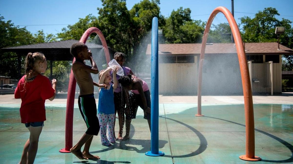 Children play at the Stephen Leonard Park splash pad in Merced, Calif., on Wednesday, June 21, 2017. According to the National Weather Service in Hanford, temperatures will stay in triple-digits throughout the weekend.