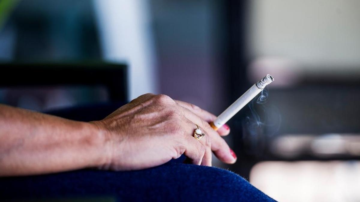 
A resident of McDowell Manor, on Park Avenue in Merced, smokes a cigarette outside her apartment.
