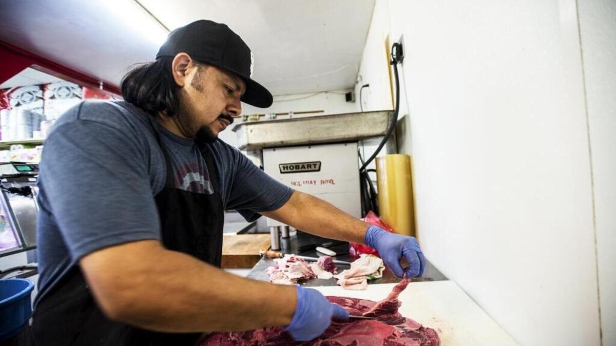Luis Morales, owner of Carniceria Rio Grande Meat Market in Merced, trims cuts of beef in October, the same month the World Health Organization placed processed meats such as bacon, hot dogs and sausage in the same danger category as smoking and asbestos exposure.