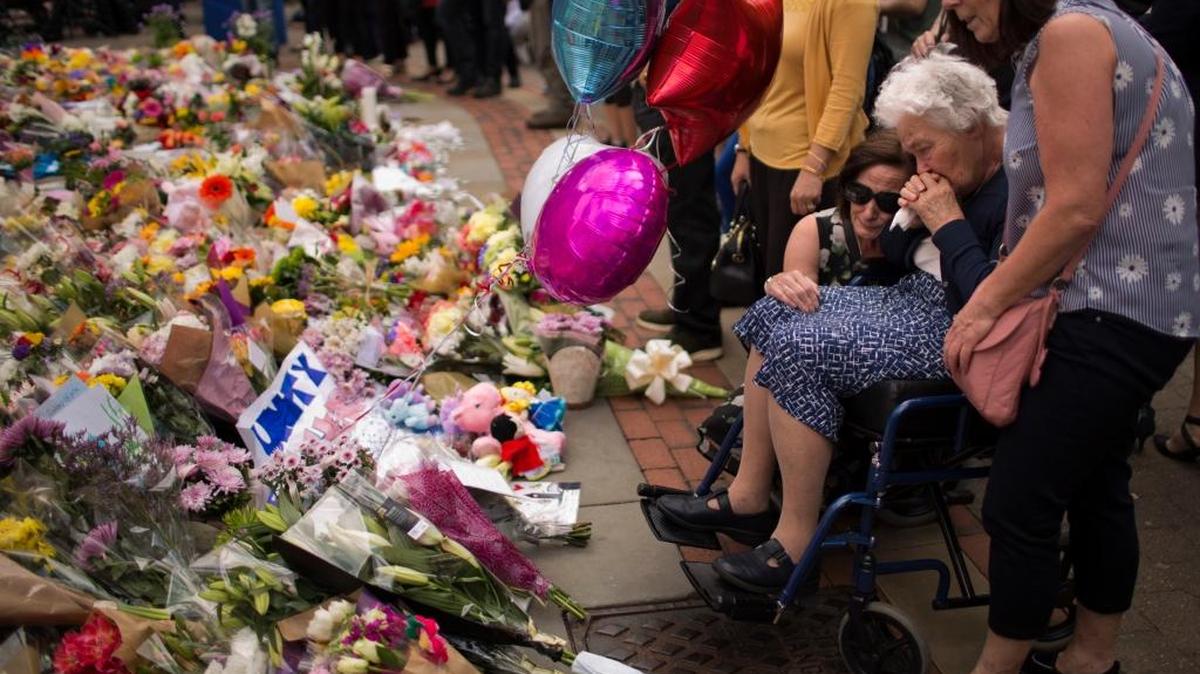 Women cry after placing flowers in a square in central Manchester, Britain, on Wednesday after the suicide attack at an Ariana Grande concert that left more than 20 people dead and many more injured. The attack occurred as the concert ended on Monday night at the Manchester Arena.