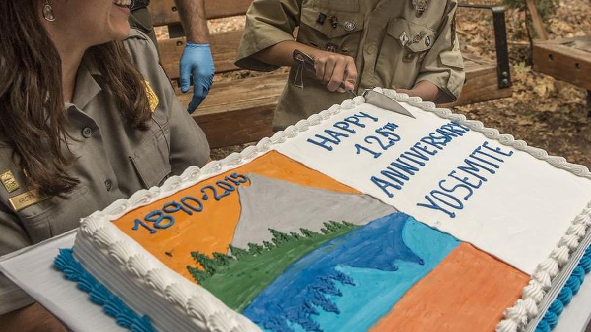 
Gabriel Lavan-Ying, better known as Ranger Gabriel, cuts a commemorative anniversary cake during Yosemite National Park’s 125th anniversary celebration on Oct. 1. Gabriel accompanied by Ranger Kristen Kosick. 
