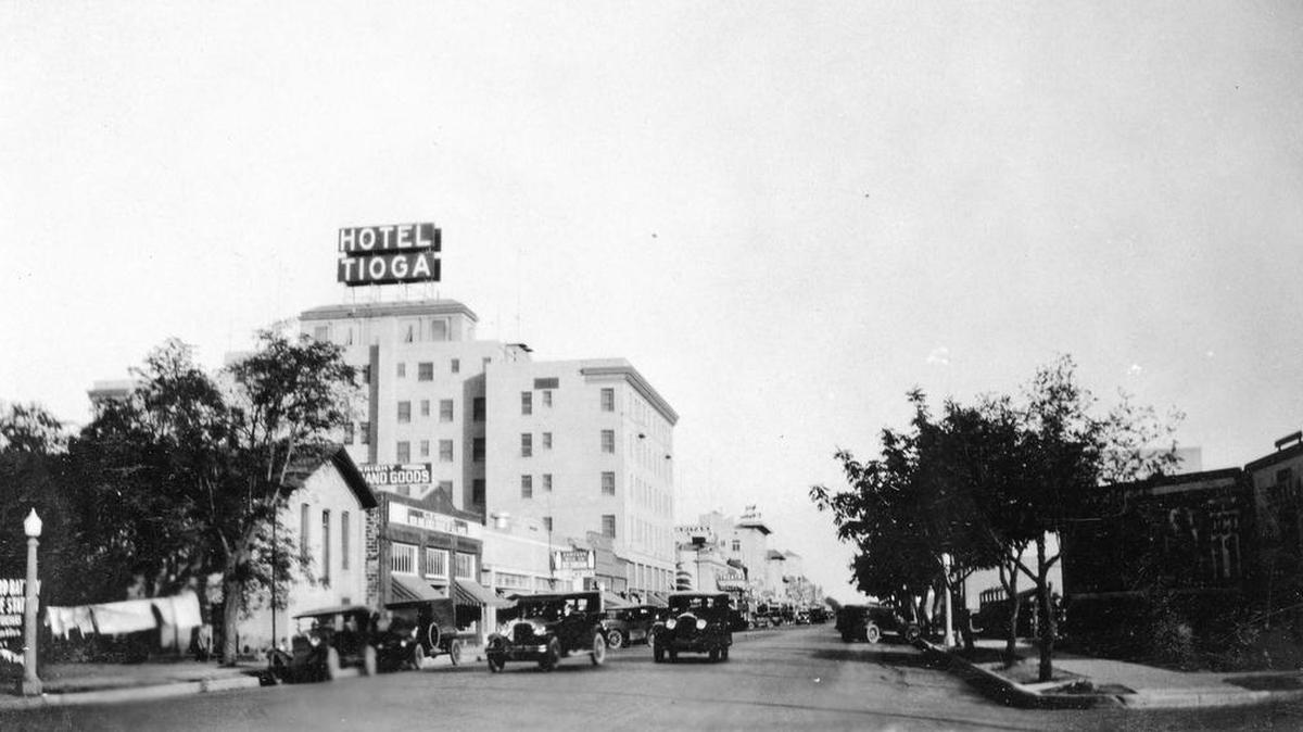 Main Street (or 17th Street) looking east, circa 1928 when the Hotel Tioga was just built. When the hotel sign was lit up at night, its red light can be seen many miles away. (Courthouse Museum Collection)