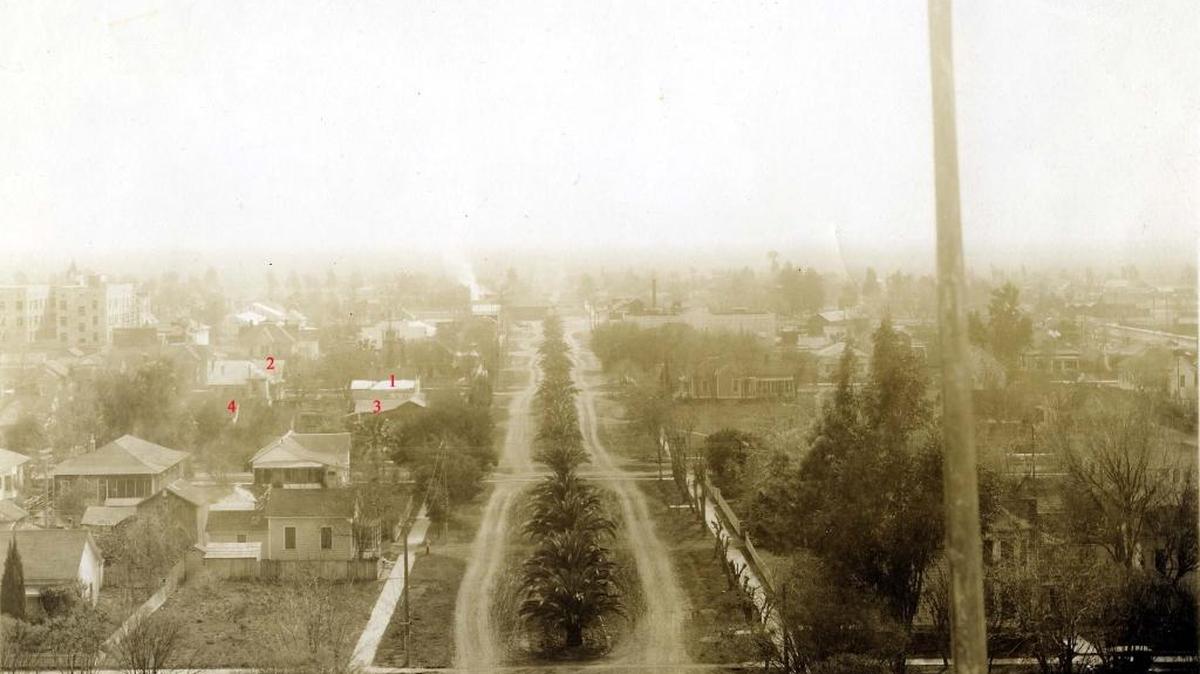 This circa 1914 photo was taken from the rooftop of the courthouse and looking south on N Street. The foreground is 20th Street. The area with numbers between 19th and 18th streets is the construction site of UC Merced Downtown Campus Center. The image of dusty streets and board sidewalks (seen here) was what Mary Belle Nuckolls Neumann remembered when she came to Merced on August 1, 1907. (Courthouse Museum Collection)
