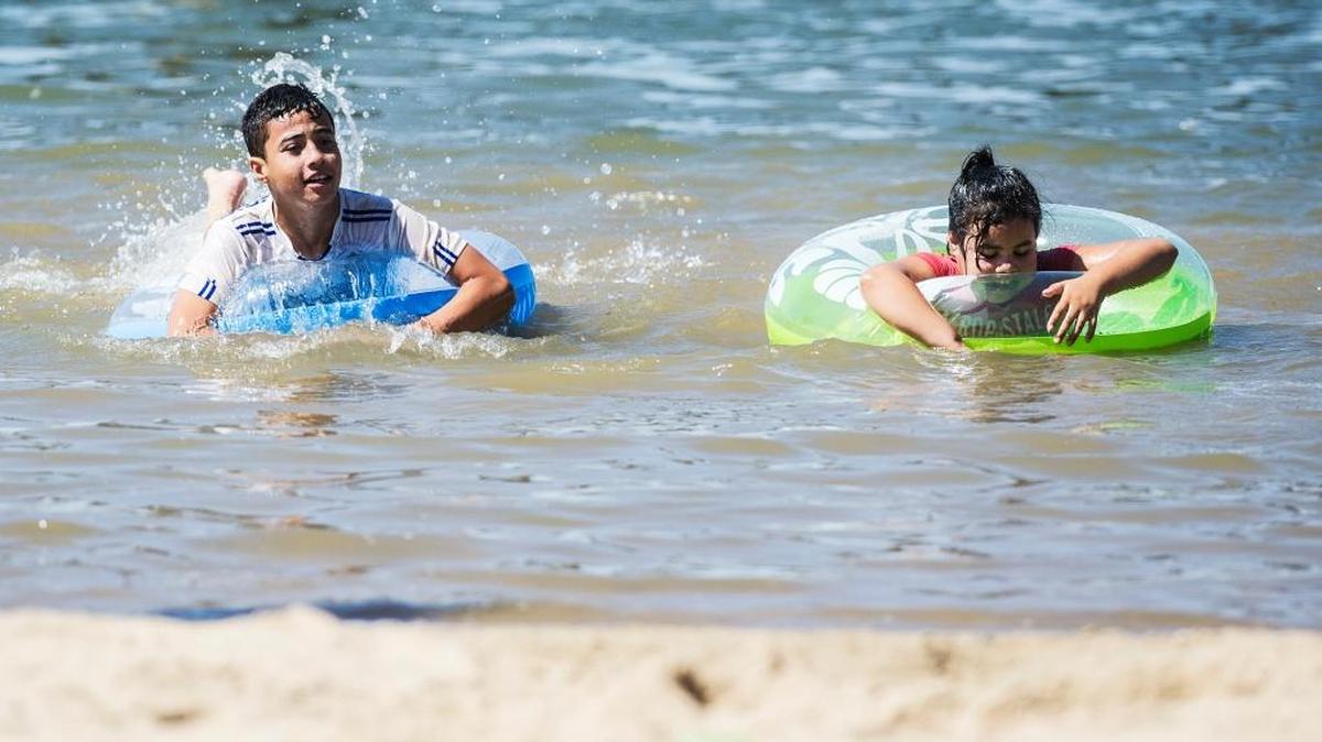 
Alfredo Rodriguez, 12, left, and Yareli Rodriguez, 8, splash around in Lake Yosemite on Labor Day in Merced.
