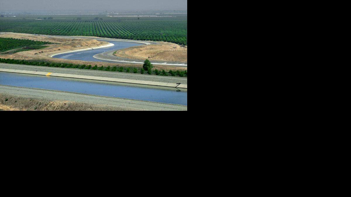 
A State Water Project aqueduct, foreground, runs next to the Delta-Mendota Canal near Patterson. With renewed doubts of supply in the fourth year of drought, water agencies south of the Delta are buying farmers’ water.
