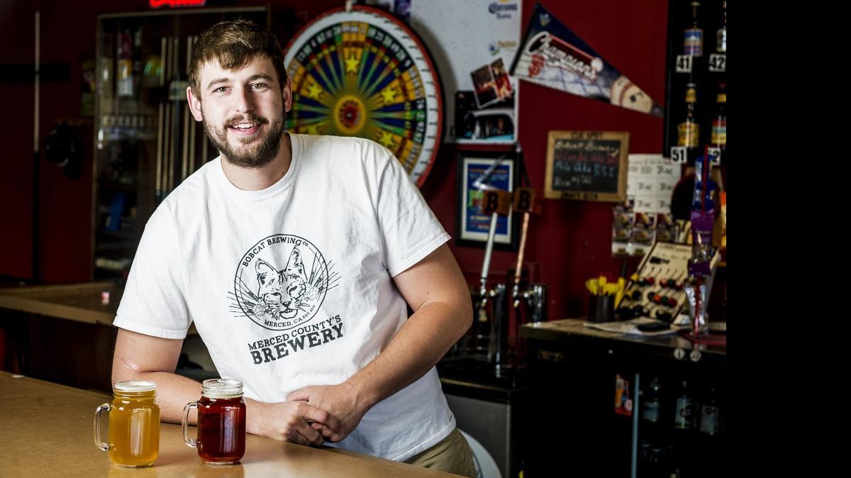 
Peter Howell, 24, of Merced, founder of Bobcat Brewing Co., is seen with a glass of Bare-Handers Blonde Ale, left, and Cat Tracks Pale Ale at Cue Spot Billiards, 450 W. Main St., Merced.
