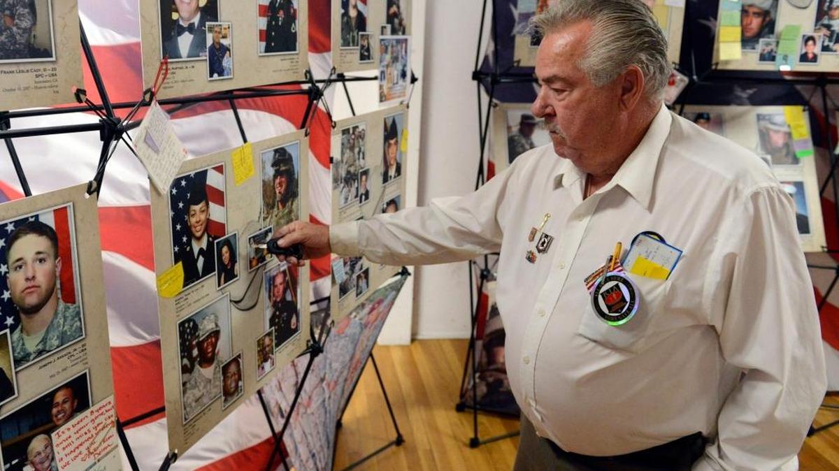 Roy Hart, 77, a member of American Legion Post 86, points to a photo of Pfc. Karina Lau, a Livingston 20-year-old killed in Iraq on Nov. 2, 2003, in the legion’s hall in Dos Palos on Oct. 10, 2015.