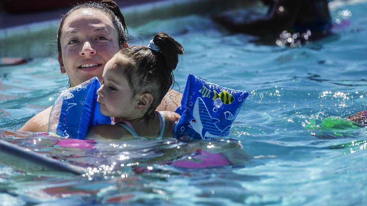 
Meghan Olmos, 27, floats with daughter Ariel Cardenas, 2, in the McNamara pool in Merced in June.
