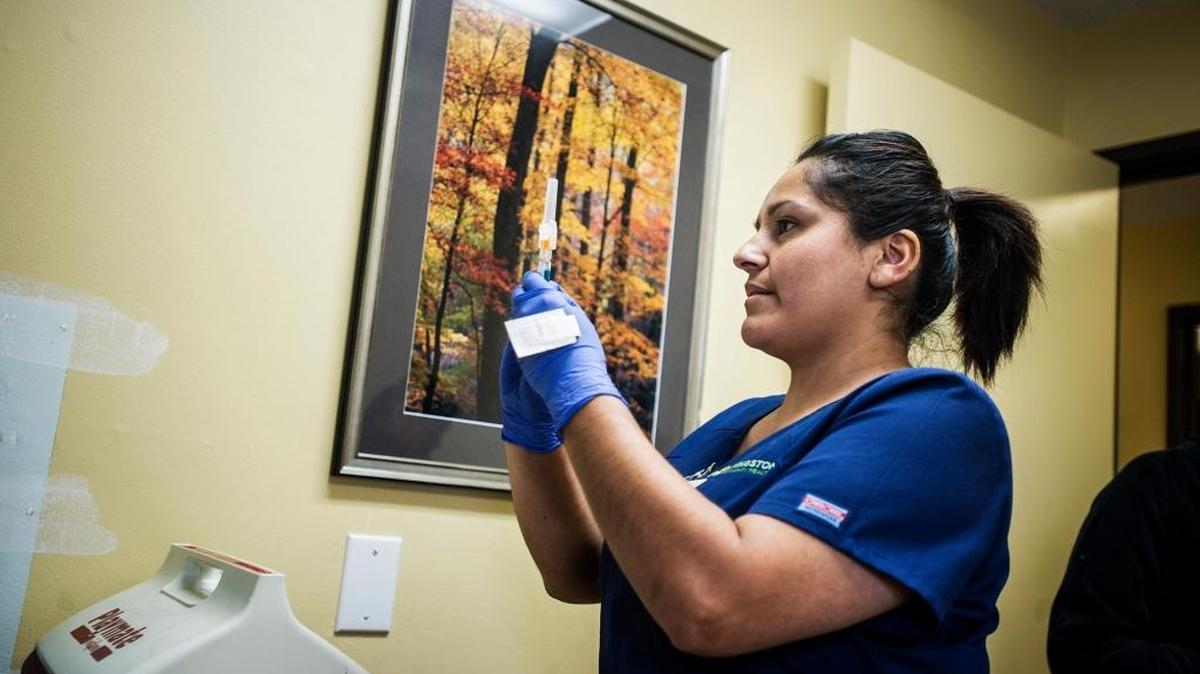 Medical assistant Maricruz Estrada readies a flu shot during the 2015 Spring Health Fair at Livingston Community Health in Livingston.