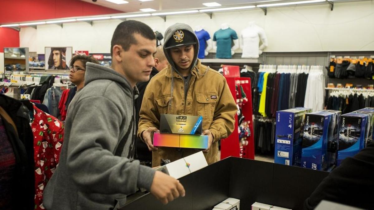 Mark Solis, 22, right, of Merced looks through electronics gear on Thanksgiving Day at Target in Merced.