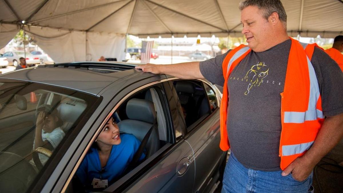 There will be a smog repair and emission testing event, Tune In and Tune Up, at the Merced County Fair Grounds on Saturday. Motorist Deja Hassen, 29, of Merced, left, speaks with Curt Ellis, 55, of Modesto, right, after testing her vehicles emissions during the Valley Clean Air Now or Valley CAN, Tune in and Tune Up event held at the Merced County Fairgrounds in Merced, Calif., Saturday, Sept. 24, 2016. The event, sponsored by the San Joaquin Valley Air Pollution Control District, aims to reduce vehicle pollutants by offering free smog testing. According to Valley CAN, if a vehicle is deemed a high polluter, Valley CAN will issue a $500 voucher for emission related repairs at local certified smog shops.