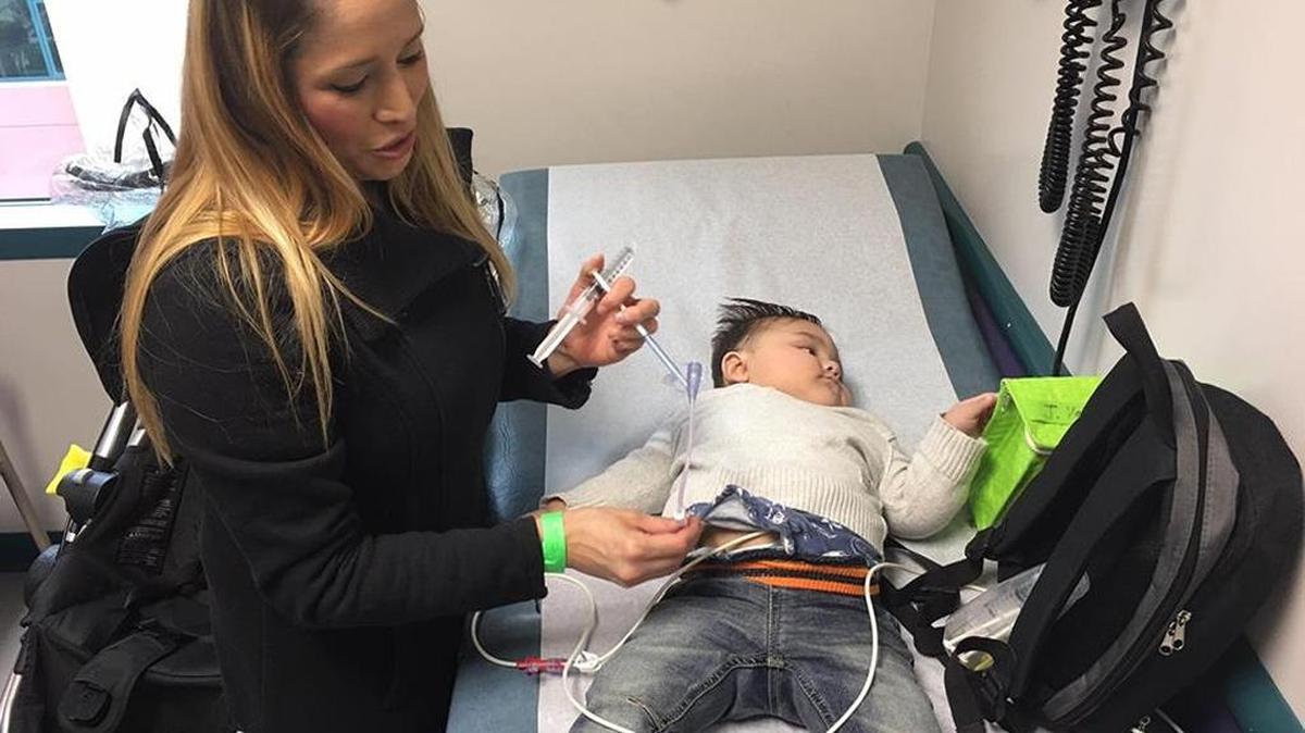 Dezi Padilla, 34, and her 1-year-old son, Jayce Valencia, are seen during a doctor’s appointment at Valley Children’s Hospital in Madera on Dec. 6. When Jayce was born his kidneys started to fail, and he has been awaiting a kidney transplant since then. To survive, he is hooked up to dialysis and a feeding pump for most of the day.