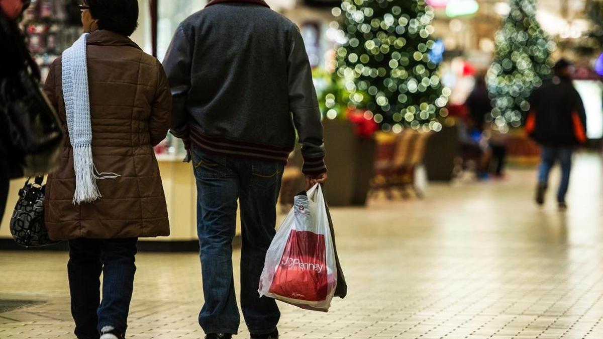Shoppers carry multiple bags of items while walking through the Merced Mall during Black Friday shopping in Merced, Calif., Friday, Nov. 27, 2015.