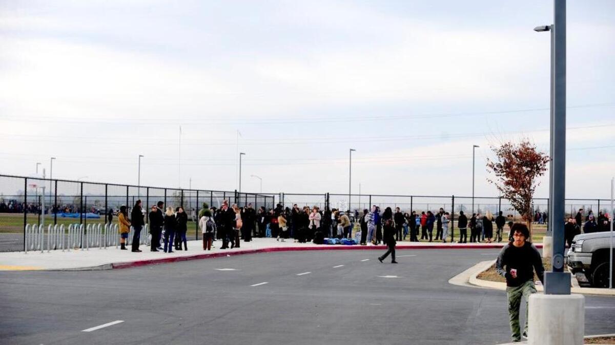 Students, faculty and staff gather in the parking lot of El Capitan High School after the campus was evacuated because of a bomb threat on Dec. 3.