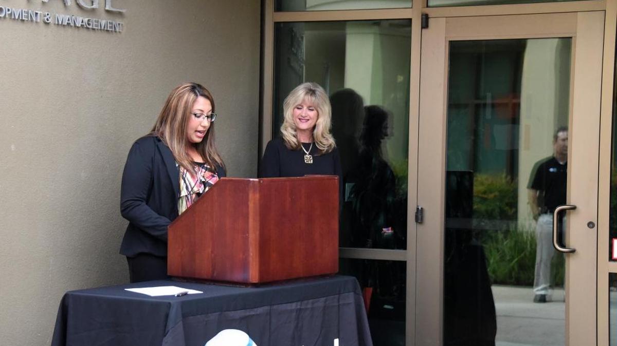 Amanda Gallegos, left, the commercial manager for Heritage Management Group, speaks at a small ceremony at the office in The Promenade on Yosemite Avenue where the business was recognized for being the first AT&T fiber-ready location in the state on Wednesday, Sept. 21, 2016.