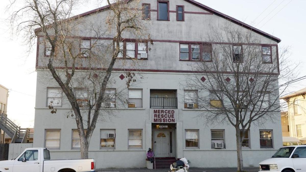 A woman sits outside the Merced County Rescue Mission in January 2015.
