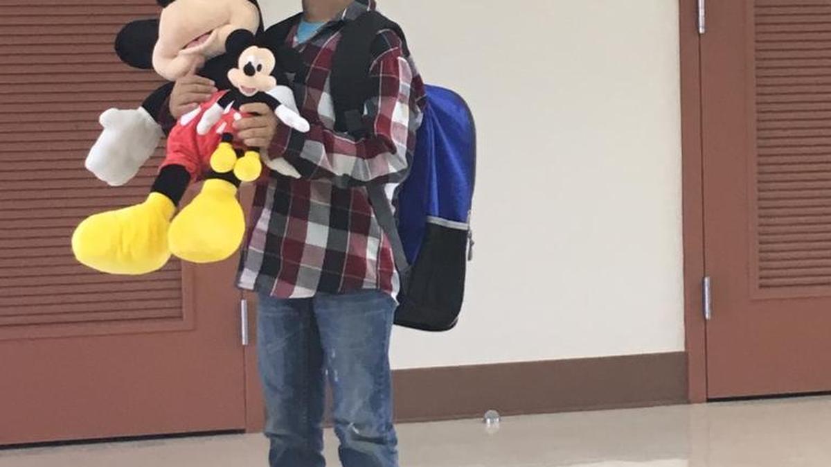 Marco Alvarez II, 8, is seen in the cafeteria at Mercey Springs Elementary School in Los Banos with gifts he received from the Make-A-Wish Foundation on Friday. His wish was to go to Disneyland with his parents and four siblings.